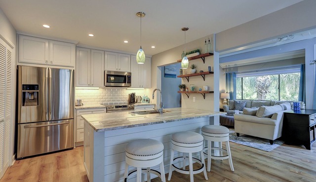 Corner unit townhome with lots of light & views of the golf course and lagoon