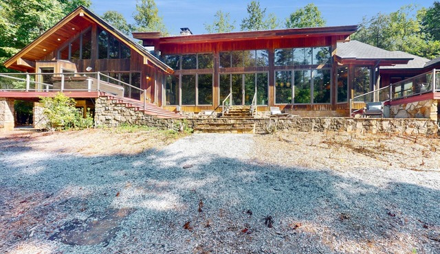 Custom riverfront retreat with private pond, dock, firepit & outdoor living