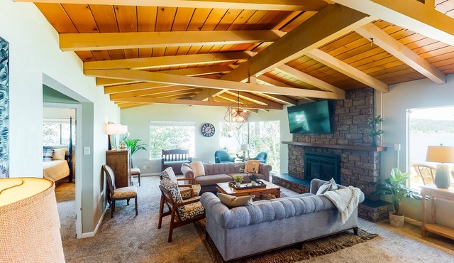 Inviting bayside dwelling with beach access, deck, waterfront views, & fireplace